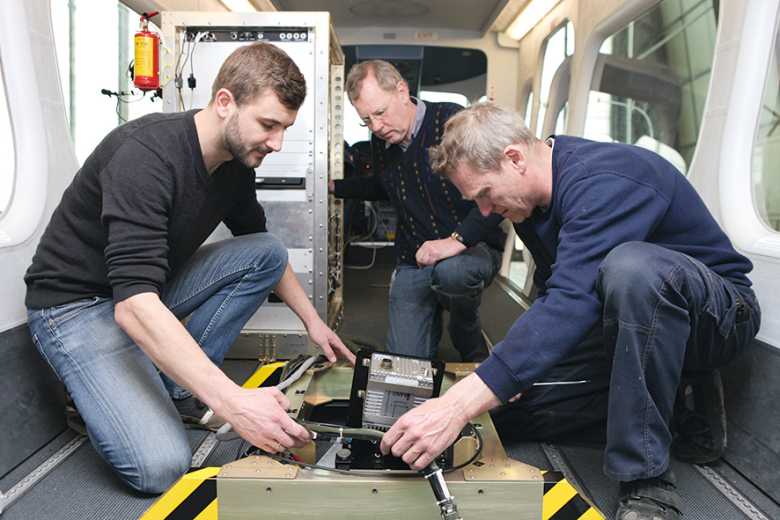 Three employees are making the final preparations for the trip